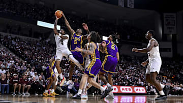 Jan 18, 2025; College Station, Texas, USA; Texas A&M Aggies guard Wade Taylor IV (4) shoots the ball as LSU Tigers guard Cam Carter (5) blocks the shot during the first half at Reed Arena. The Aggies defeated the Tigers 68-57. Mandatory Credit: Maria Lysaker-Imagn Images 