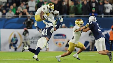 Jan 9, 2025; Miami, FL, USA; (Editors Note: Caption Correction) Notre Dame Fighting Irish running back Jeremiyah Love (4) leaps over Penn State Nittany Lions linebacker Kobe King (41) in the second half in the Orange Bowl at Hard Rock Stadium. Mandatory Credit: Sam Navarro-Imagn Images