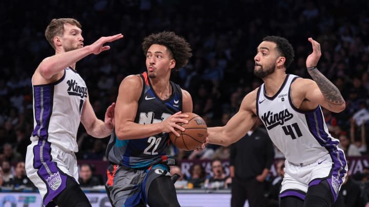 Apr 7, 2024; Brooklyn, New York, USA; Brooklyn Nets forward Jalen Wilson (22) looks to pass as Sacramento Kings forward Domantas Sabonis (10) and forward Trey Lyles (41) defends during the second half at Barclays Center. Mandatory Credit: Vincent Carchietta-USA TODAY Sports