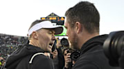 Nov 22, 2025; Eugene, Oregon, USA; Southern California Trojans head coach Lincoln Riley and Oregon Ducks head coach Dan Lanning greet each other after the game at Autzen Stadium. Mandatory Credit: Troy Wayrynen-Imagn Images