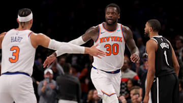 Jan 23, 2024; Brooklyn, New York, USA; New York Knicks forward Julius Randle (30) high fives guard Josh Hart (3) in front of Brooklyn Nets forward Mikal Bridges (1) during the fourth quarter at Barclays Center. Mandatory Credit: Brad Penner-Imagn Images