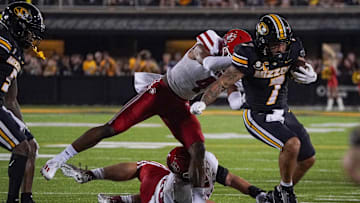 Aug 31, 2023; Columbia, Missouri, USA; Missouri Tigers running back Cody Schrader (7) runs the ball and is pushed out of bounds by South Dakota Coyotes defensive back Shahid Barros (4) during the first half at Faurot Field at Memorial Stadium. Mandatory Credit: Denny Medley-Imagn Images