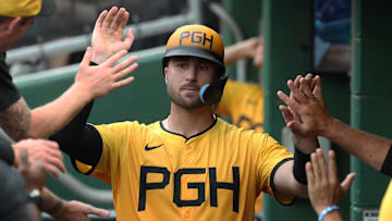 Jun 27, 2025; Pittsburgh, Pennsylvania, USA;  Pittsburgh Pirates catcher Joey Bart (14) celebrates in the dugout after scoring a run against the New York Mets during the second inning at PNC Park. Mandatory Credit: Charles LeClaire-Imagn Images