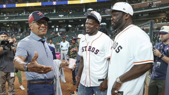 Jul 30, 2024; Houston, Texas, USA; Reggie Jackson (left) talks with Andre Johnson (middle) and rapper 50 Cent (right).