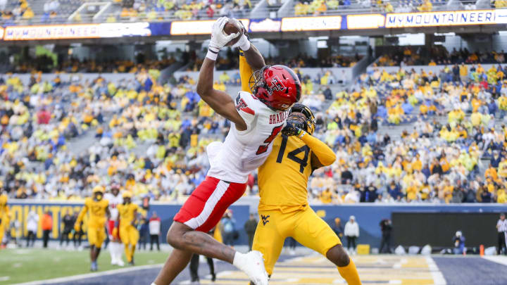 Sep 23, 2023; Morgantown, West Virginia, USA; Texas Tech Red Raiders wide receiver Jerand Bradley (9) catches a pass for a touchdown over West Virginia Mountaineers cornerback Malachi Ruffin (14) during the fourth quarter at Mountaineer Field at Milan Puskar Stadium. Mandatory Credit: Ben Queen-USA TODAY Sports