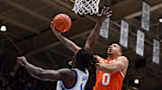 Jan 14, 2025; Durham, North Carolina, USA; Miami Hurricanes guard Matthew Cleveland (0) shoots over Duke Blue Devils guard Sion James (14) during the first half at Cameron Indoor Stadium. Mandatory Credit: Rob Kinnan-Imagn Images