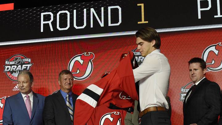 Nico Hischier puts on a team jersey after being selected as the number one overall pick to the New Jersey Devils in the first round of the 2017 NHL Draft at United Center. Mandatory Credit: David Banks-Imagn Images