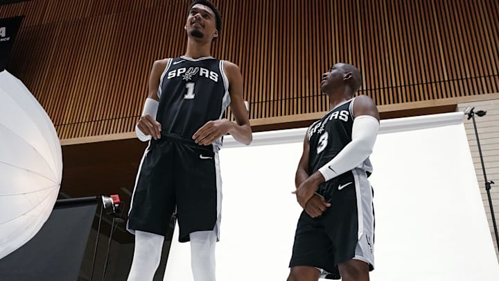 San Antonio Spurs guard Chris Paul looks up to Victor Wembanyama during the team's media day.