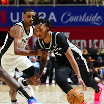 Jul 13, 2024; Las Vegas, NV, USA; San Antonio Spurs guard Stephon Castle (5) dribbles around Portland Trail Blazers forward Kris Murray (10) as San Antonio Spurs forward Nathan Mensah (31) sets a pick during the second quarter at Thomas & Mack Center. Mandatory Credit: Stephen R. Sylvanie-Imagn Images