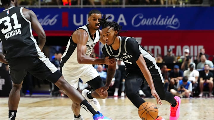 Jul 13, 2024; Las Vegas, NV, USA; San Antonio Spurs guard Stephon Castle (5) dribbles around Portland Trail Blazers forward Kris Murray (10) as San Antonio Spurs forward Nathan Mensah (31) sets a pick during the second quarter at Thomas & Mack Center. Mandatory Credit: Stephen R. Sylvanie-Imagn Images