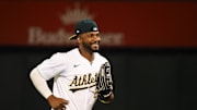 Jul 22, 2024; Oakland, California, USA; Oakland Athletics left fielder Miguel Andujar (22) smiles after a win against the Houston Astros at Oakland-Alameda County Coliseum. Mandatory Credit: Kelley L Cox-USA TODAY Sports