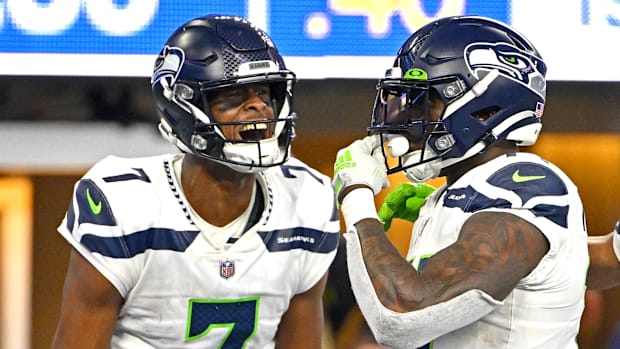 Seattle Seahawks quarterback Geno Smith (7) celebrates with wide receiver DK Metcalf (14) after a touchdown.