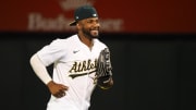 Jul 22, 2024; Oakland, California, USA; Oakland Athletics left fielder Miguel Andujar (22) smiels after a win against the Houston Astros at Oakland-Alameda County Coliseum. 