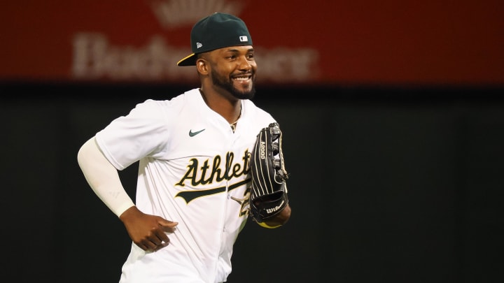 Jul 22, 2024; Oakland, California, USA; Oakland Athletics left fielder Miguel Andujar (22) smiels after a win against the Houston Astros at Oakland-Alameda County Coliseum. 