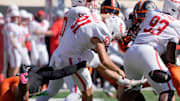 Oklahoma State Cowboys safety Landyn Cleveland (14) tries to tackle Houston Cougars punter Liam Dougherty (91) as he punts during a college football game between the Oklahoma State Cowboys (OSU) and the Houston Cougars at Boone Pickens Stadium in Stillwater, Okla., Saturday, Oct. 11, 2025.