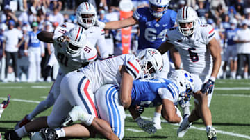 Oct 12, 2024; Provo, Utah, USA; Arizona Wildcats linebacker Lance Keneley (90) tackles Brigham Young Cougars running back LJ Martin (27) during the third quarter at LaVell Edwards Stadium. Mandatory Credit: Rob Gray-Imagn Images