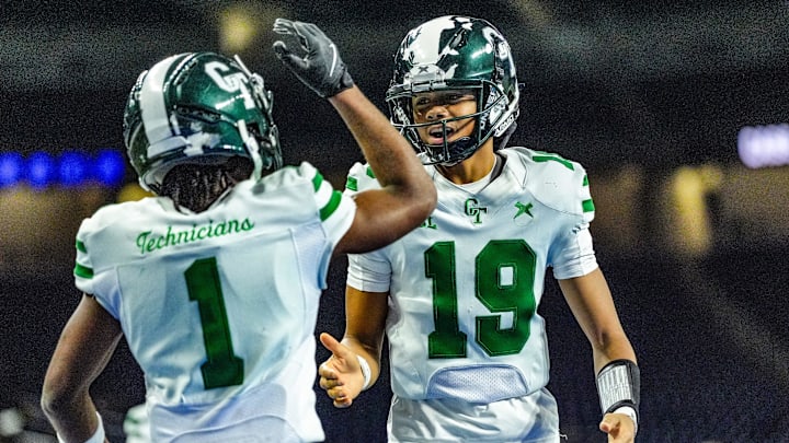 Detroit Cass Tech QB Donald Tabron II (19) celebrates Corey Sadler Jr.’s (1) touchdown against Hudsonville in the second quarter during the MHSAA Division 1 football finals at Ford Field in Detroit on Saturday, Nov. 30, 2024.