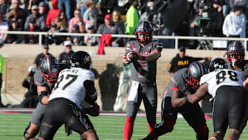 Nov 9, 2024; Lubbock, Texas, USA; Texas Tech Red Raiders quarterback Behren Morton (2) takes a snap from center in the first half against the Colorado Buffalos at Jones AT&T Stadium and Cody Campbell Field. Mandatory Credit: Michael C. Johnson-Imagn Images