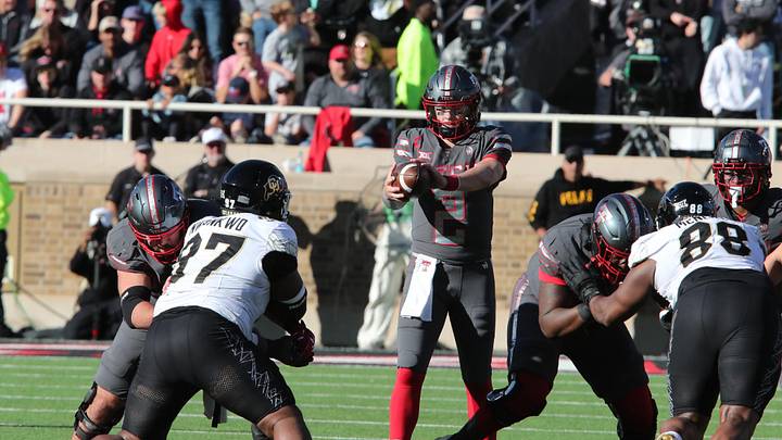 Nov 9, 2024; Lubbock, Texas, USA; Texas Tech Red Raiders quarterback Behren Morton (2) takes a snap from center in the first half against the Colorado Buffalos at Jones AT&T Stadium and Cody Campbell Field. Mandatory Credit: Michael C. Johnson-Imagn Images