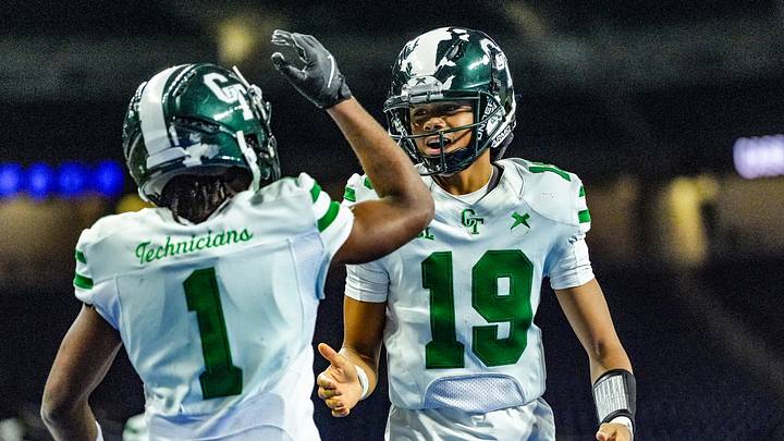 Detroit Cass Tech QB Donald Tabron II (19) celebrates Corey Sadler Jr.’s (1) touchdown against Hudsonville in the second quarter during the MHSAA Division 1 football finals at Ford Field in Detroit on Saturday, Nov. 30, 2024.