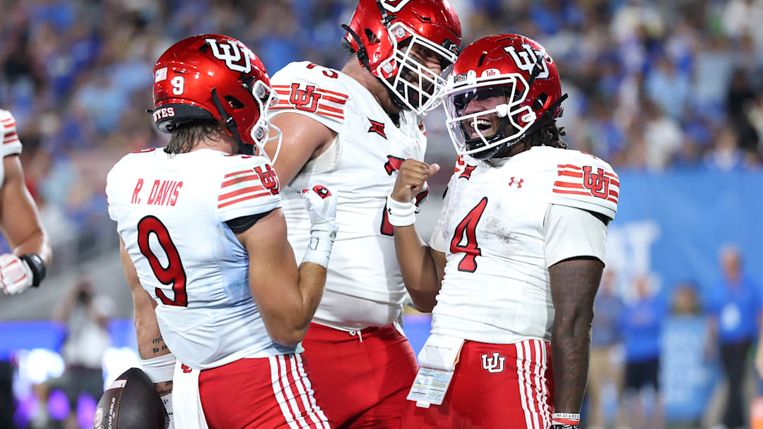  Ryan Davis #9 congratulates Devon Dampier #4 of the Utah Utes after his rushing touchdown during the second half of a game against the UCLA Bruins at Rose Bowl Stadium on August 30, 2025 in Pasadena, California.