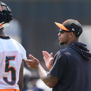 Jul 26, 2024; Cincinnati, OH, USA; Cincinnati Bengals wide receiver Ja'Marr Chase (right) encourages teammates as he talks with wide receiver Tee Higgins (5) during training camp practice at Kettering Health Practice Fields. Mandatory Credit: Kareem Elgazzar-Imagn Images