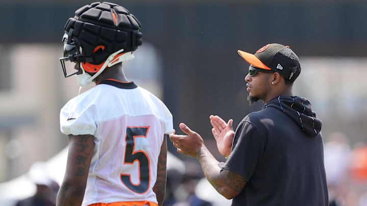 Jul 26, 2024; Cincinnati, OH, USA; Cincinnati Bengals wide receiver Ja'Marr Chase (right) encourages teammates as he talks with wide receiver Tee Higgins (5) during training camp practice at Kettering Health Practice Fields. Mandatory Credit: Kareem Elgazzar-Imagn Images