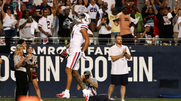 Aug 31, 2024; Tucson, Arizona, USA; Arizona Wildcats wide receiver Tetairoa McMillan (4) celebrates a touchdown during first quarter at Arizona Stadium. at Arizona Stadium. Mandatory Credit: Aryanna Frank-USA TODAY Sports