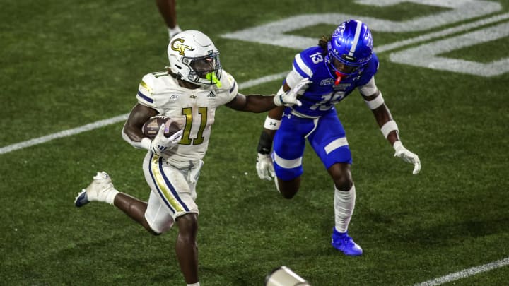 Aug 31, 2024; Atlanta, Georgia, USA; Georgia Tech Yellow Jackets running back Jamal Haynes (11) runs the ball past Georgia State Panthers safety Isaiah Holland (13) in the second quarter at Bobby Dodd Stadium at Hyundai Field. Mandatory Credit: Brett Davis-USA TODAY Sports