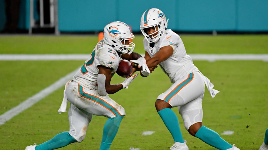 Miami Dolphins quarterback Tua Tagovailoa (1) hands the ball to running back Matt Breida (22) during the second half against the New York Jets at Hard Rock Stadium.  | Jasen Vinlove-Imagn Images