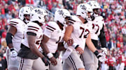 Mississippi State Bulldogs quarterback Kamario Taylor (1) celebrates with teammates after scoring a touchdown during the third quarter against the Arkansas Razorbacks at Donald W. Reynolds Razorback Stadium. Bulldogs won 38-35.