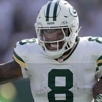 Green Bay Packers running back Josh Jacobs (8) stiff-arms Houston Texans safety Eric Murray.