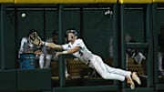 Jun 15, 2024; Omaha, NE, USA;  Texas A&M Aggies left fielder Caden Sorrell (13) attempts a diving catch against the Florida Gators during the seventh inning at Charles Schwab Field Omaha. Mandatory Credit: Steven Branscombe-Imagn Images
