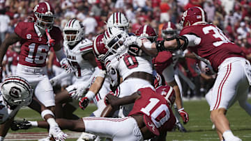 Oct 12, 2024; Tuscaloosa, Alabama, USA;  South Carolina Gamecocks running back Juju McDowell (0) is wrapped up by Alabama defenders at Bryant-Denny Stadium. Alabama defeated South Carolina 27-25. Mandatory Credit: Gary Cosby Jr.-Imagn Images