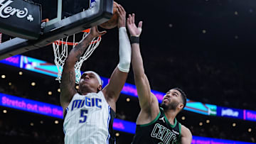 Apr 29, 2025; Boston, Massachusetts, USA; Boston Celtics forward Jayson Tatum (0) defends against Orlando Magic forward Paolo Banchero (5) in the second quarter during game five of first round for the 2025 NBA Playoffs at TD Garden. Mandatory Credit: David Butler II-Imagn Images