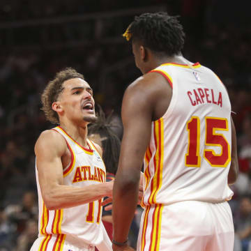 Mar 31, 2022; Atlanta, Georgia, USA; Atlanta Hawks guard Trae Young (11) and center Clint Capela (15) celebrate after an alley oop against the Cleveland Cavaliers in the second half at State Farm Arena. Mandatory Credit: Brett Davis-USA TODAY Sports
