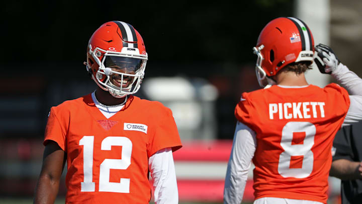Cleveland Browns quarterback Shedeur Sanders (12) shares a laugh with quarterback Kenny Pickett (8) during NFL training camp practice at the Cleveland Browns training facility, Wednesday, July 23, 2025, in Berea, Ohio.
