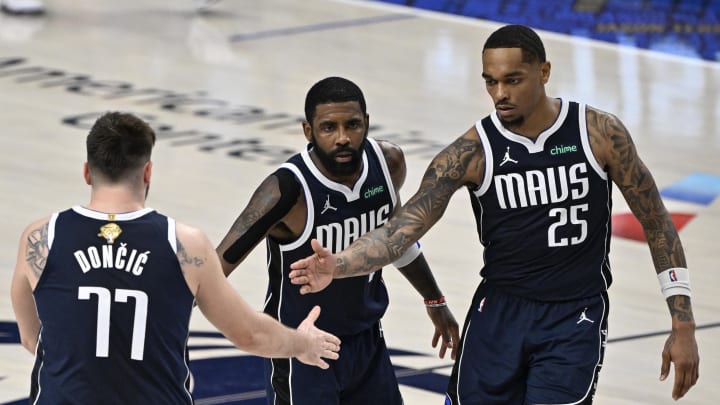 Jun 12, 2024; Dallas, Texas, USA; Dallas Mavericks guard Kyrie Irving (11) and forward P.J. Washington (25) celebrate with guard Luka Doncic (77) after a play during the fourth quarter in game three of the 2024 NBA Finals against the Boston Celtics at American Airlines Center. Mandatory Credit: Jerome Miron-USA TODAY Sports