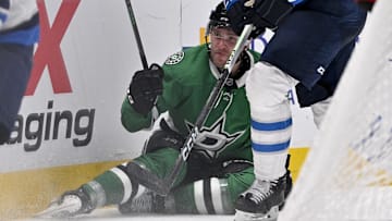 Apr 10, 2025; Dallas, Texas, USA; Dallas Stars right wing Mikko Rantanen (96) is taken down by Winnipeg Jets defenseman Dylan Samberg (54) during the second period at the American Airlines Center. Mandatory Credit: Jerome Miron-Imagn Images