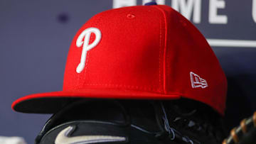 May 26, 2023; Atlanta, Georgia, USA; A detailed view of a Philadelphia Phillies hat and glove on the bench against the Atlanta Braves in the seventh inning at Truist Park. 
