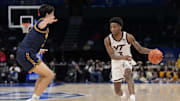 Mar 11, 2025; Charlotte, NC, USA; Virginia Tech Hokies guard Jaydon Young (3) brings the ball up court against California Golden Bears guard Andrej Stojakovic (2) during the second half at Spectrum Center. Mandatory Credit: Jim Dedmon-Imagn Images