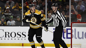 Mar 11, 2025; Boston, Massachusetts, USA; Boston Bruins defenseman Nikita Zadorov (91) is escorted to the penalty box after being called for a penalty during the third period against the Florida Panthers at TD Garden. Mandatory Credit: Winslow Townson-Imagn Images