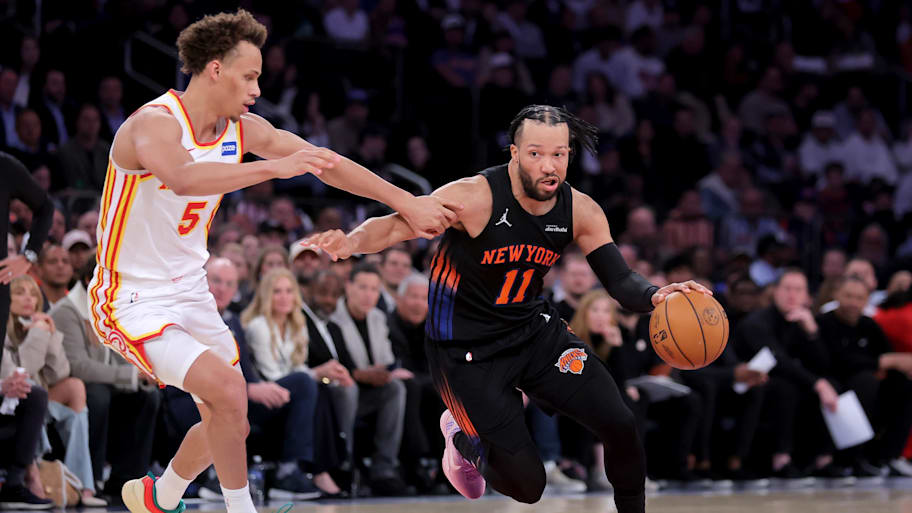New York Knicks guard Jalen Brunson controls the ball against Atlanta Hawks guard Dyson Daniels.