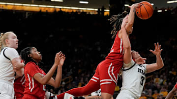 Rutgers Scarlet Knights guard Mya Petticord and Iowa Hawkeyes guard Sydney Affolter