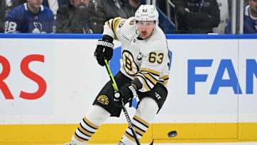 May 2, 2024; Toronto, Ontario, CAN;   Boston Bruins forward Brad Marchand (63) passes the puck against the Toronto Maple Leafs in the first period in game six of the first round of the 2024 Stanley Cup Playoffs at Scotiabank Arena. Mandatory Credit: Dan Hamilton-Imagn Images