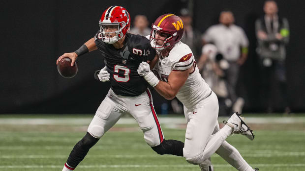 Atlanta Falcons quarterback Desmond Ridder (9) is tackled for a loss by Washington Commanders defensive end Casey Toohill 