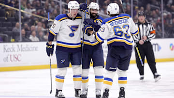 Mar 8, 2025; Los Angeles, California, USA; St. Louis Blues defenseman Nick Leddy (4) celebrates with defenseman Tyler Tucker (75) and left wing Jake Neighbours (63) after scoring against the Los Angeles Kings during the third period at Crypto.com Arena. Mandatory Credit: Ryan Sun-Imagn Images