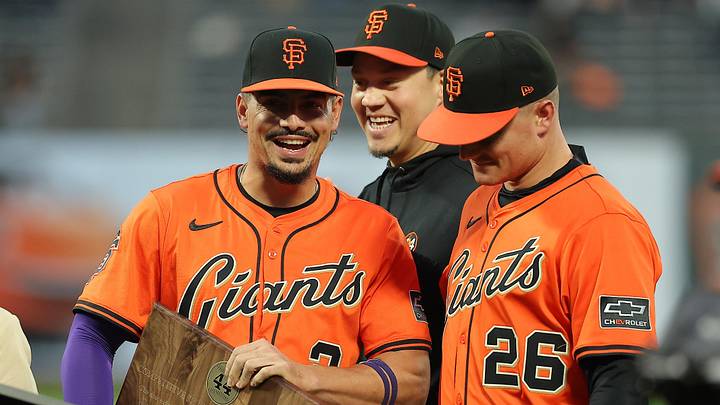 Sep 26, 2025; San Francisco, California, USA; San Francisco Giants shortstop Willy Adames (left) with Wilmer Flores (center) and Matt Chapman (right) as he receives the Willie Mac award before the game against the Colorado Rockies at Oracle Park. Mandatory Credit: Kelley L Cox-Imagn Images