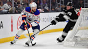Dec 28, 2024; Los Angeles, California, USA; Edmonton Oilers center Leon Draisaitl (29) moves the puck against Los Angeles Kings forward Samuel Helenius (79) during the third period at Crypto.com Arena. Mandatory Credit: Gary A. Vasquez-Imagn Images
