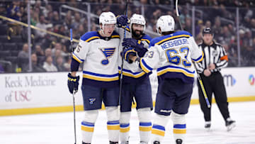 Mar 8, 2025; Los Angeles, California, USA; St. Louis Blues defenseman Nick Leddy (4) celebrates with defenseman Tyler Tucker (75) and left wing Jake Neighbours (63) after scoring against the Los Angeles Kings during the third period at Crypto.com Arena. Mandatory Credit: Ryan Sun-Imagn Images